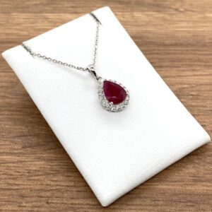 A Ruby & Diamond Pear Halo Cluster Pendant, 1.44ct with a ruby stone and diamonds.