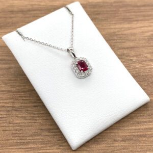 A Ruby & Diamond Rectangular Cluster Pendant with a ruby stone and diamonds.