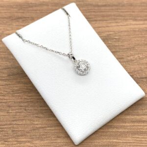 A white box with a Diamond Round Halo Cluster Pendant, 0.40ct on it.