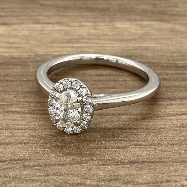 Oval diamond engagement ring with halo setting.