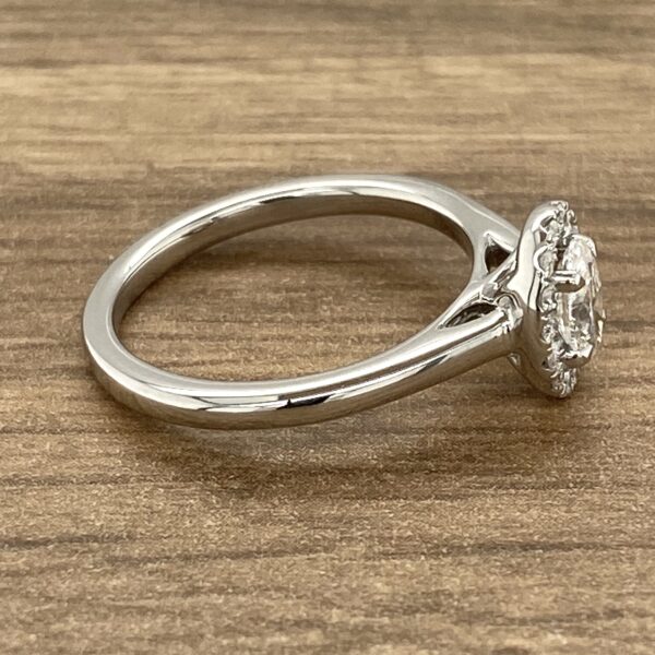 Silver ring with a diamond halo setting.