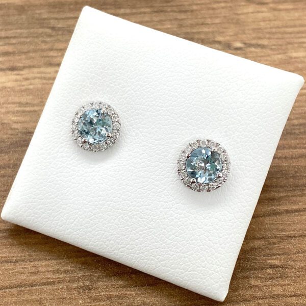Aquamarine and diamond halo earrings.