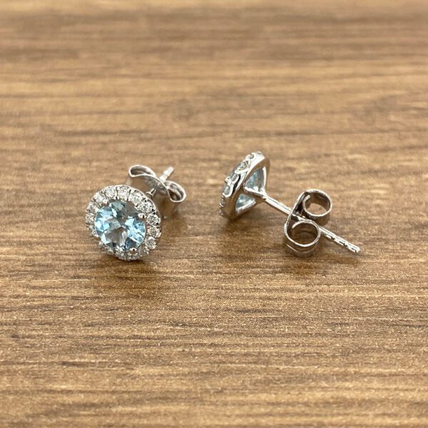 Silver earrings with blue gemstones.