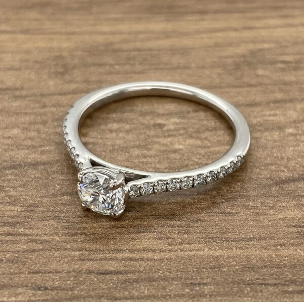 Diamond engagement ring with pave band.