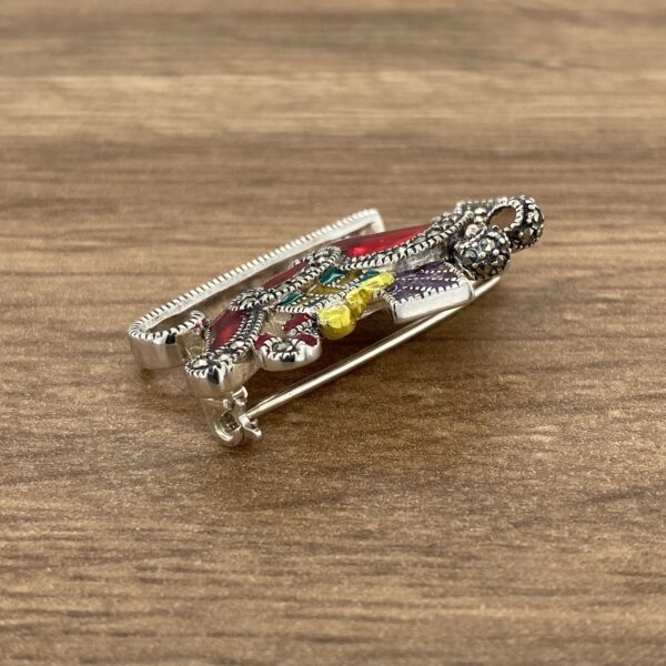 Colorful enamel and marcasite brooch.