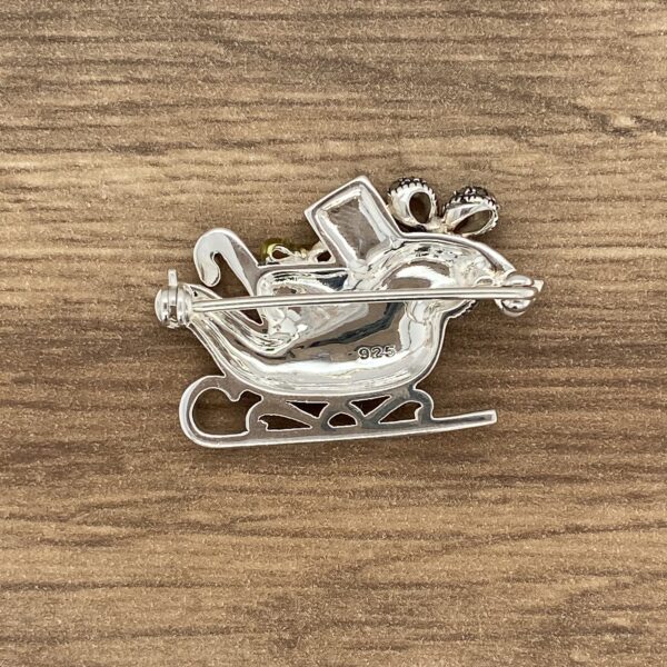 Silver Santa sleigh pin with rhinestones.