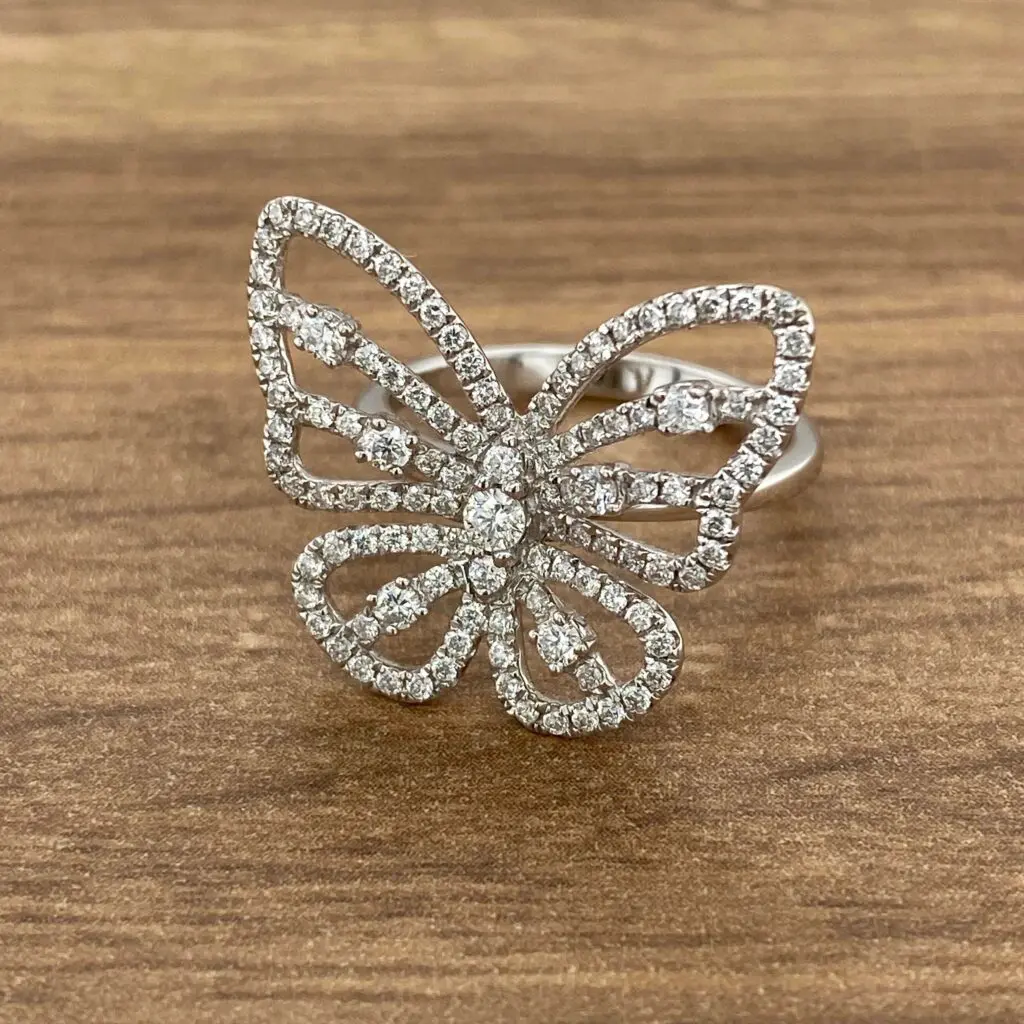 Diamond butterfly ring on wood background.