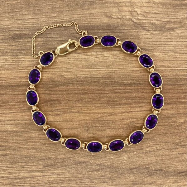 Gold bracelet with oval amethyst stones.