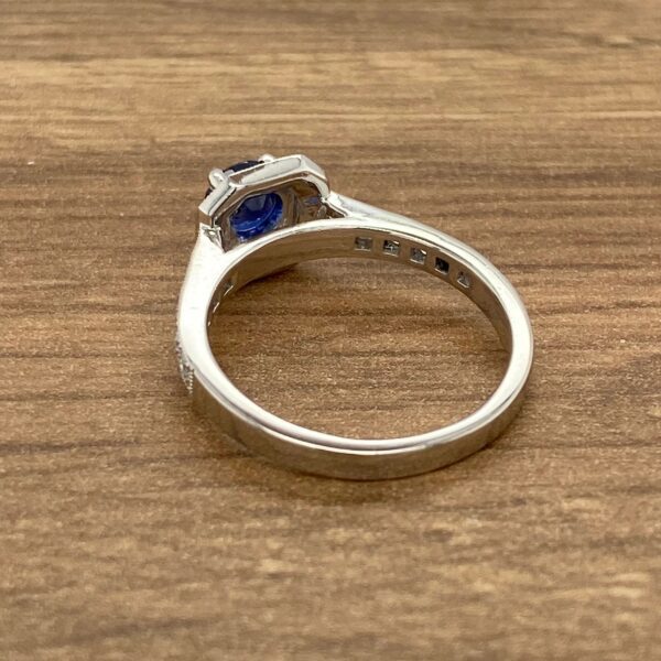 Silver ring with blue gemstone and diamonds.