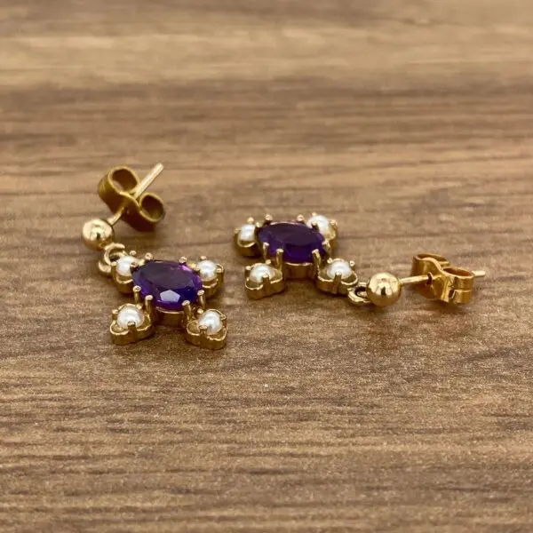 Gold cross earrings with amethyst and pearls.