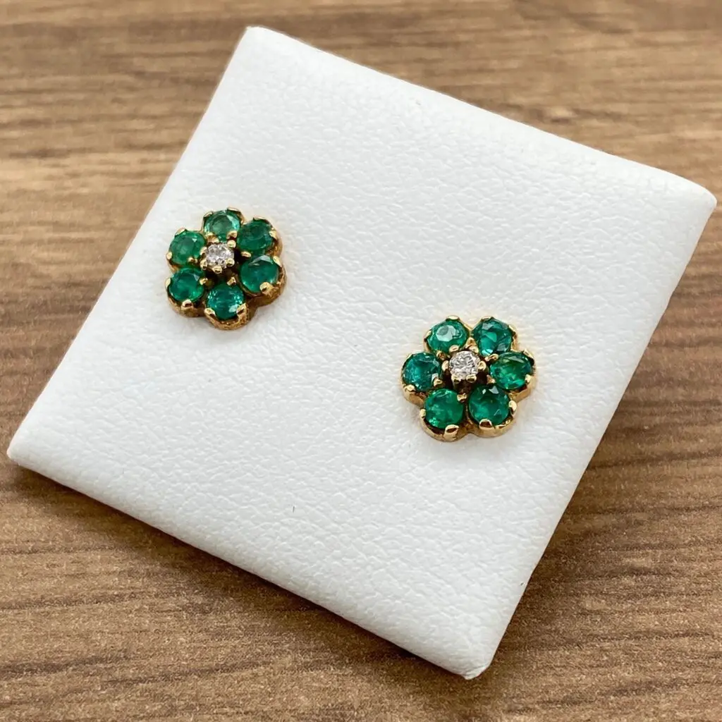 Emerald and diamond flower earrings.