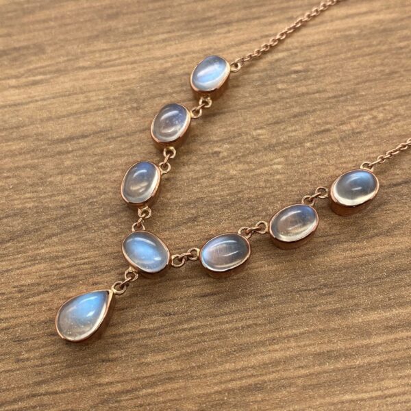 Gold necklace with moonstone pendants.