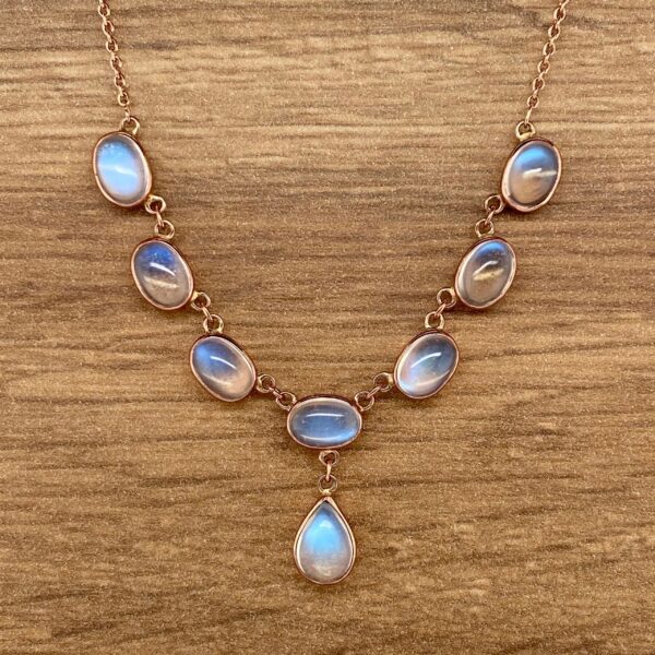 Gold necklace with moonstone pendant.