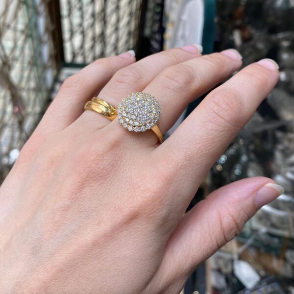 Gold ring with round diamond cluster.