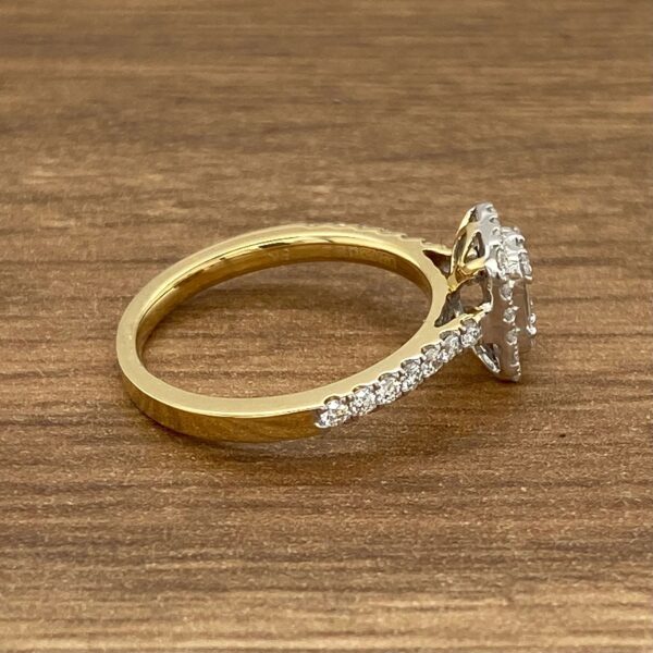 Gold ring with a halo diamond setting.