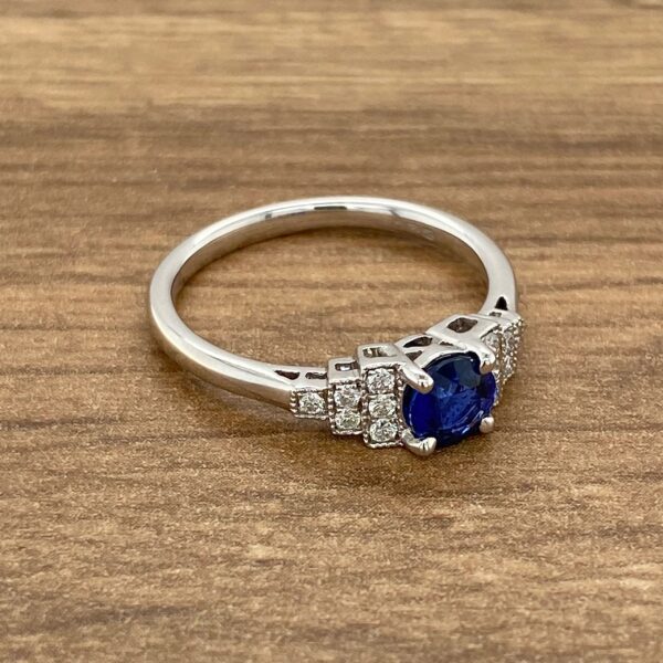 White gold ring with blue sapphire and diamonds.