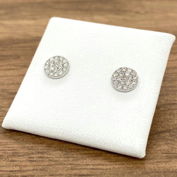 Round diamond stud earrings on display.