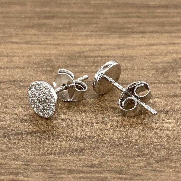 Silver stud earrings with diamond accents.