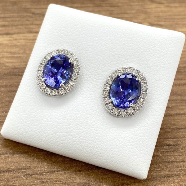 Pair of oval sapphire and diamond earrings.