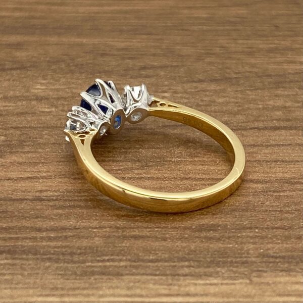 Gold ring with blue and white stones.