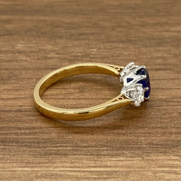 Gold ring with sapphire and diamond accents.