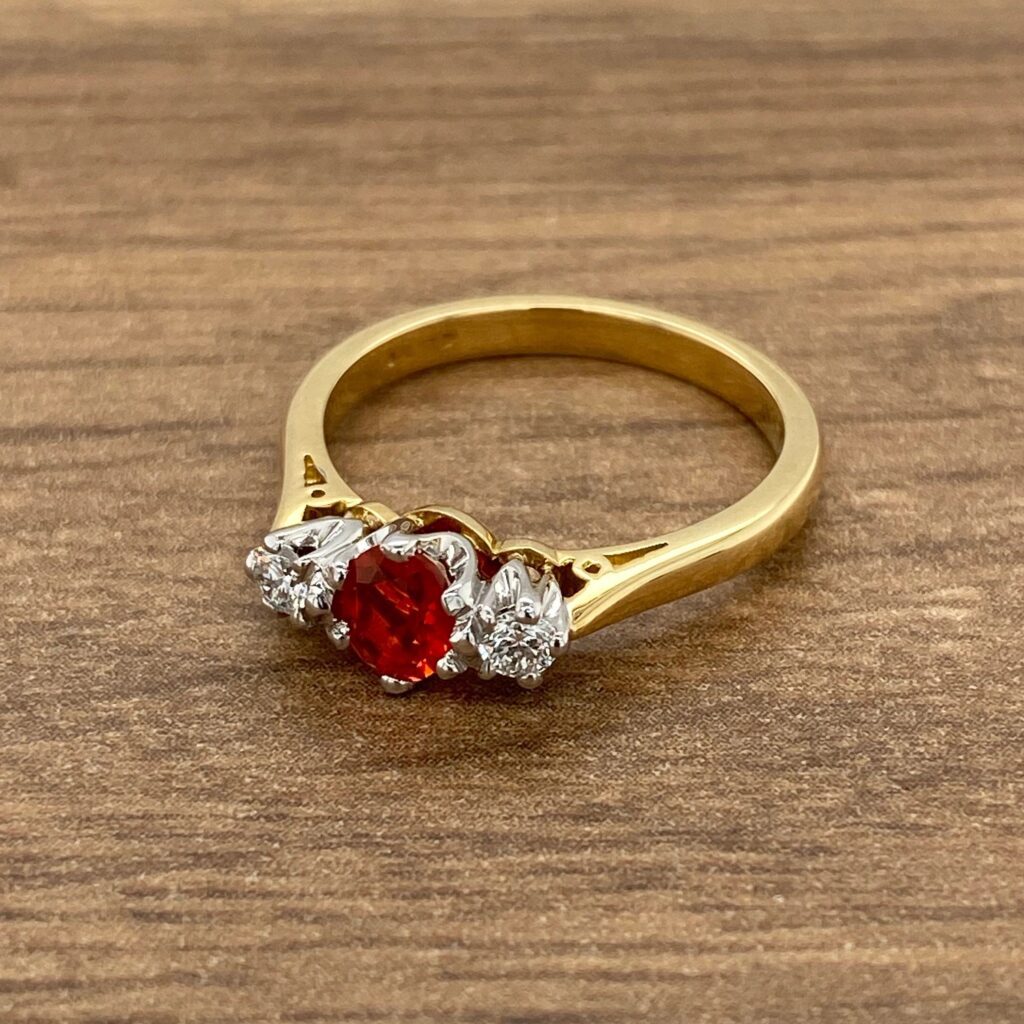 Gold ring with red and white stones.