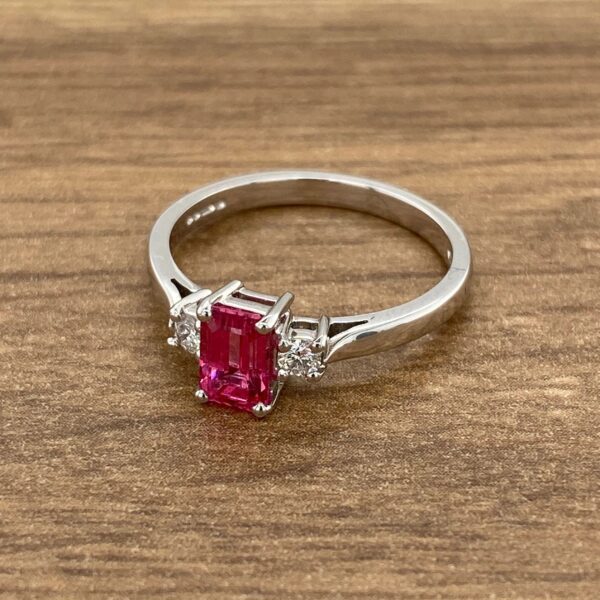 White gold ring with pink gemstone and diamonds.