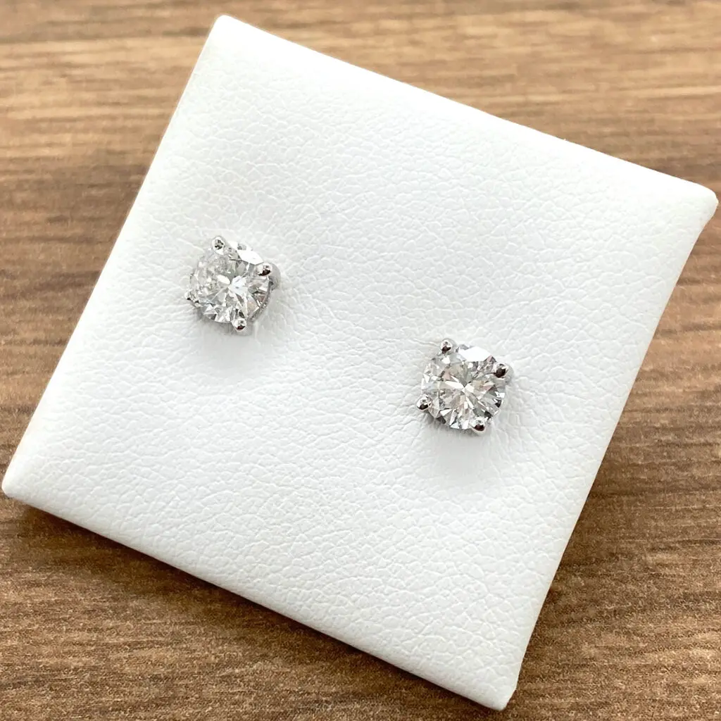 Pair of round diamond stud earrings.