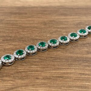 An Emerald & Diamond Halo Cluster Bracelet.