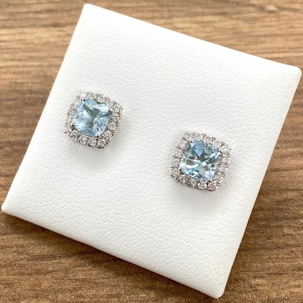 Aquamarine and diamond halo earrings.