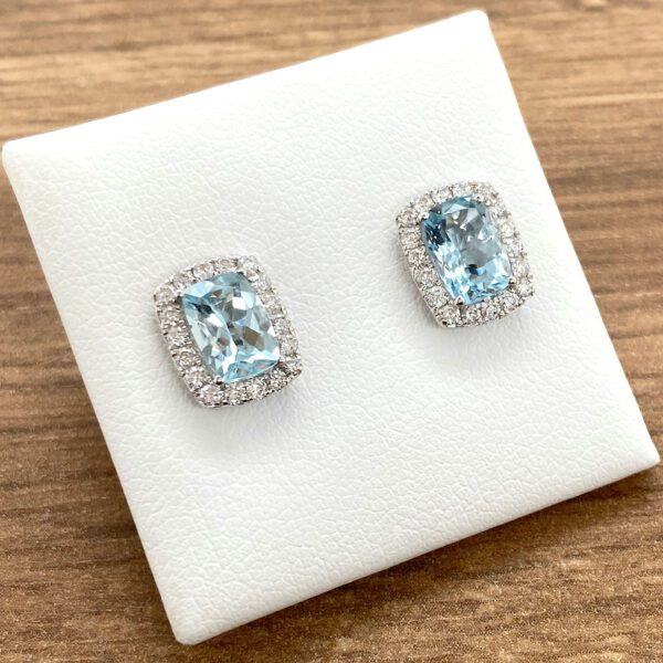 Aquamarine and diamond halo earrings.