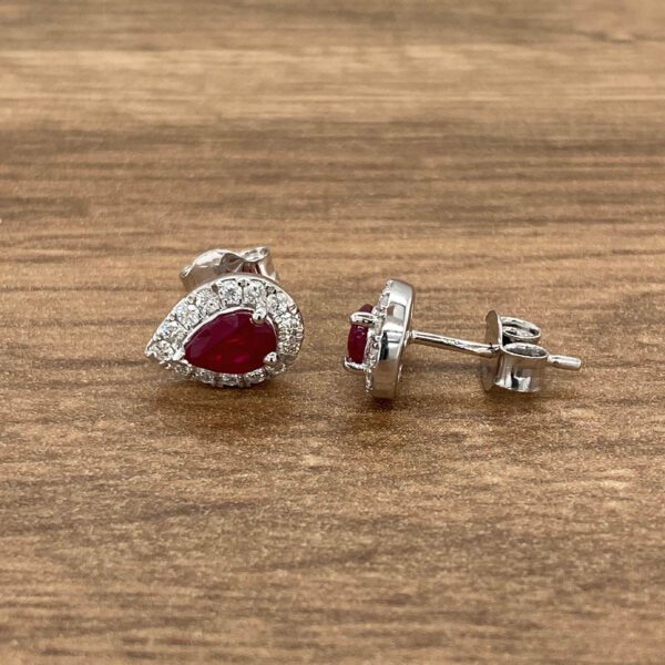 Pair of pear-shaped ruby earrings with diamond halo.