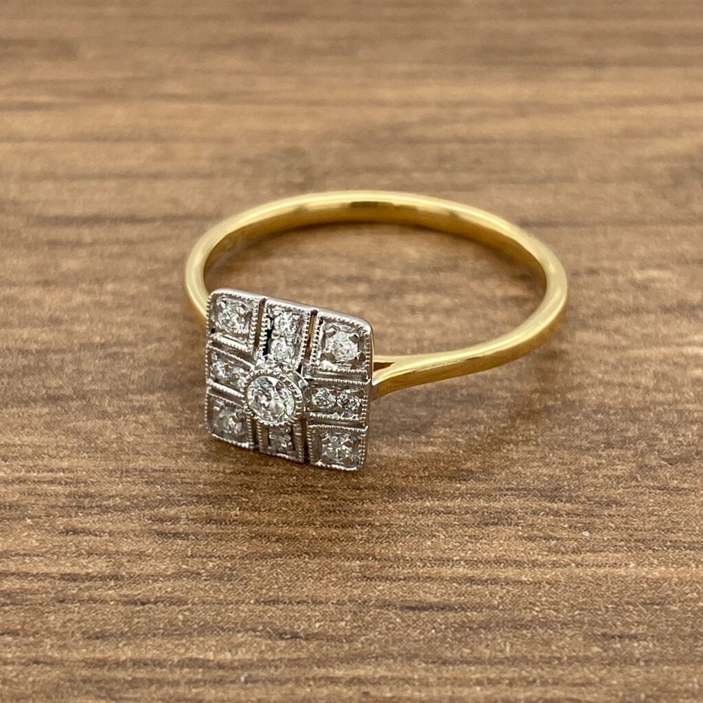 Gold ring with square diamond setting.