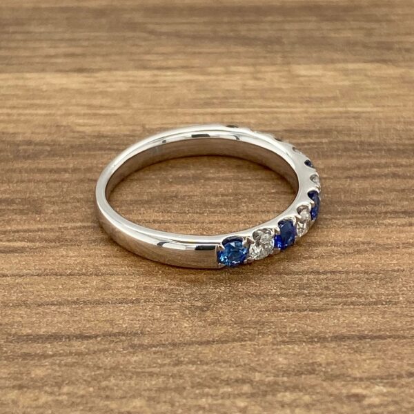 White gold band with blue sapphires.