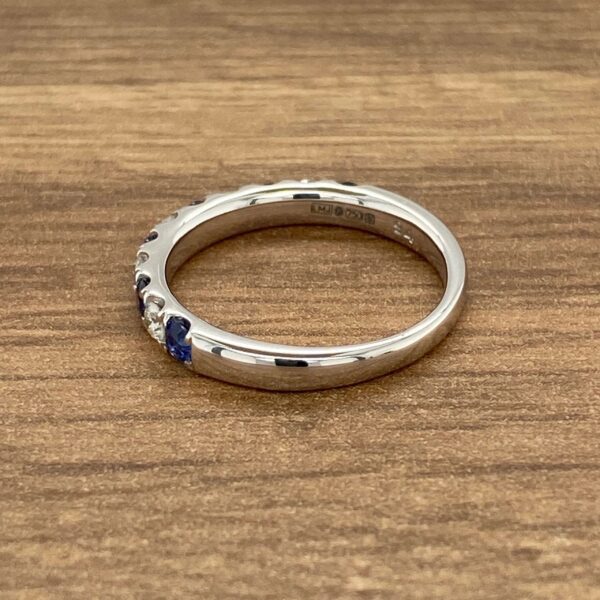 White gold band with blue sapphires.