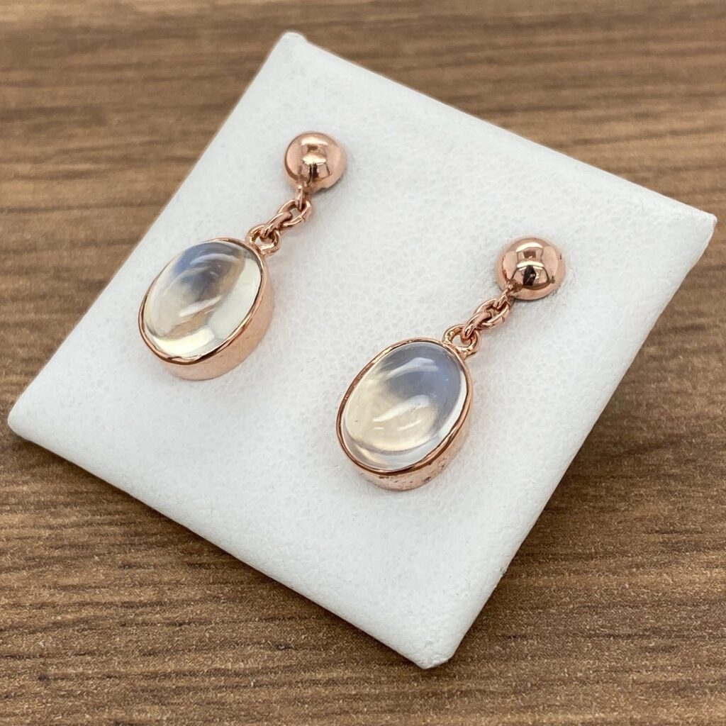 Rose gold oval moonstone earrings.