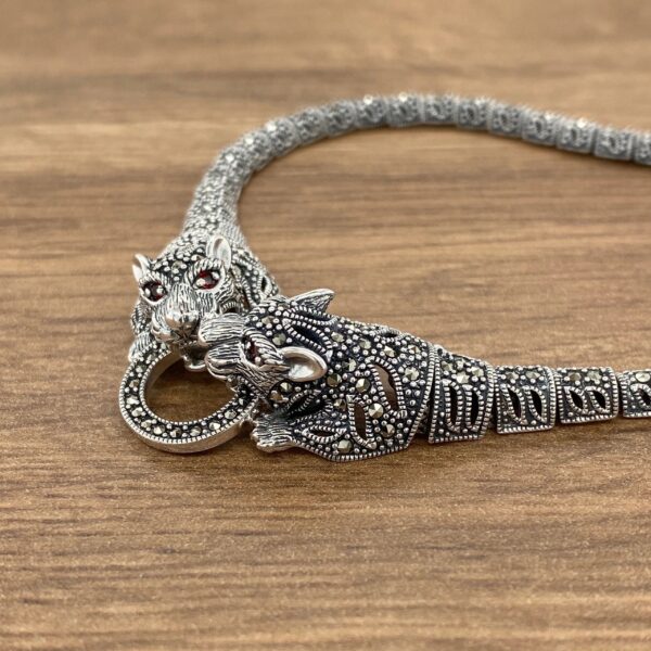 Silver tiger necklace with red eyes.