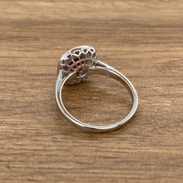 Silver ring with pink and white stones.