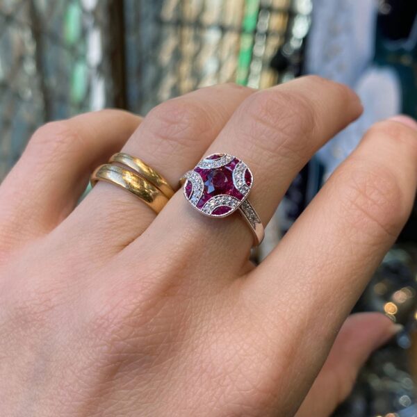 Hand wearing a ruby and diamond ring.