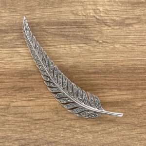 Silver feather brooch with marcasite stones.