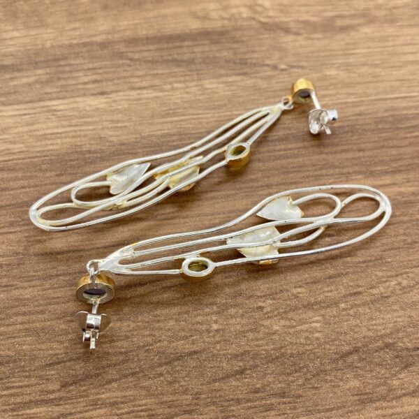 Silver and gold leaf drop earrings.