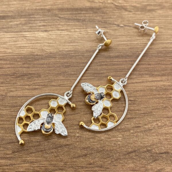 Silver and gold bee honeycomb earrings.