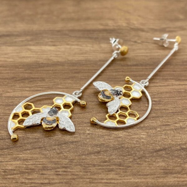 Silver and gold bee honeycomb earrings.