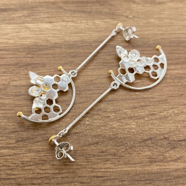 Silver honeycomb earrings with gold accents.