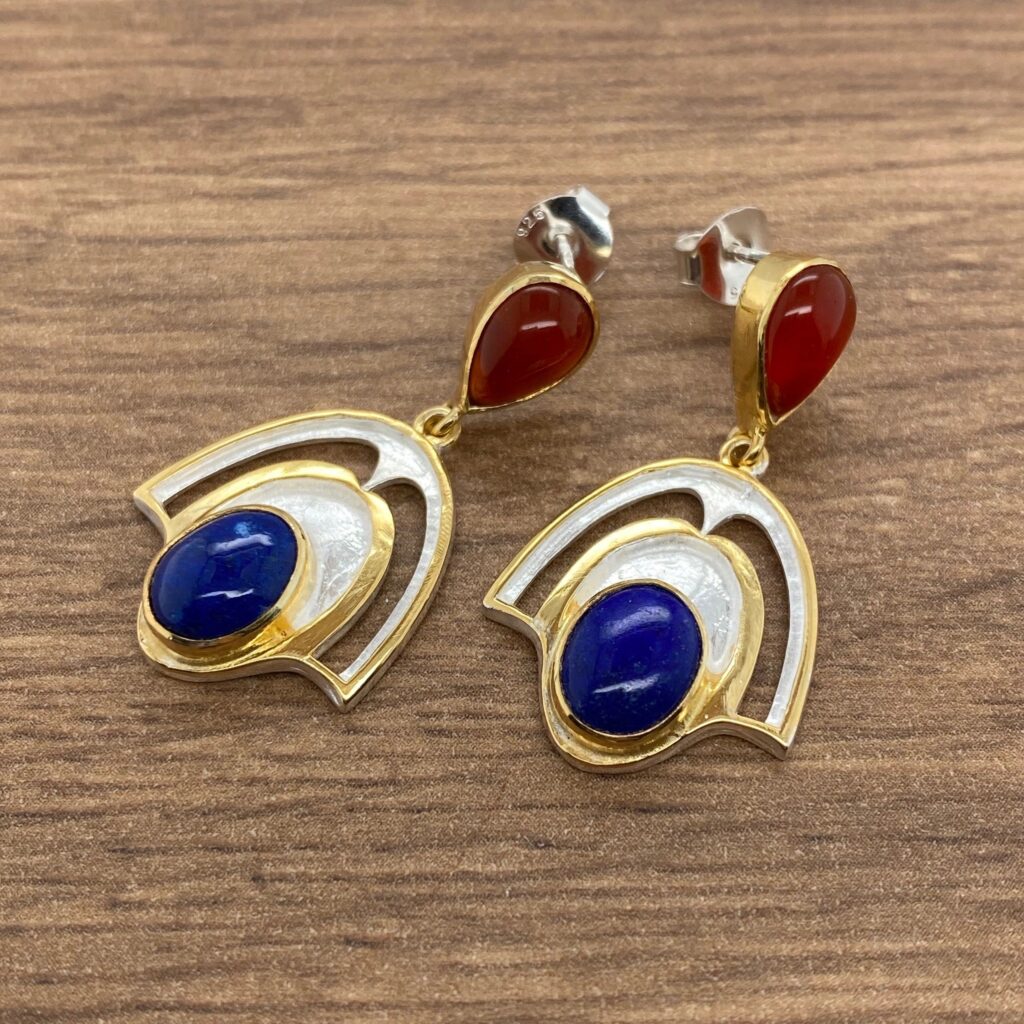 Silver and gold earrings with blue and red stones.