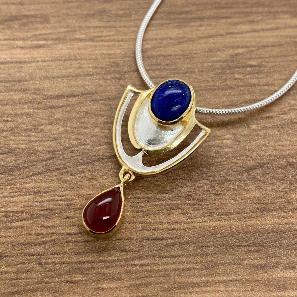 Gold necklace with blue and red stones.