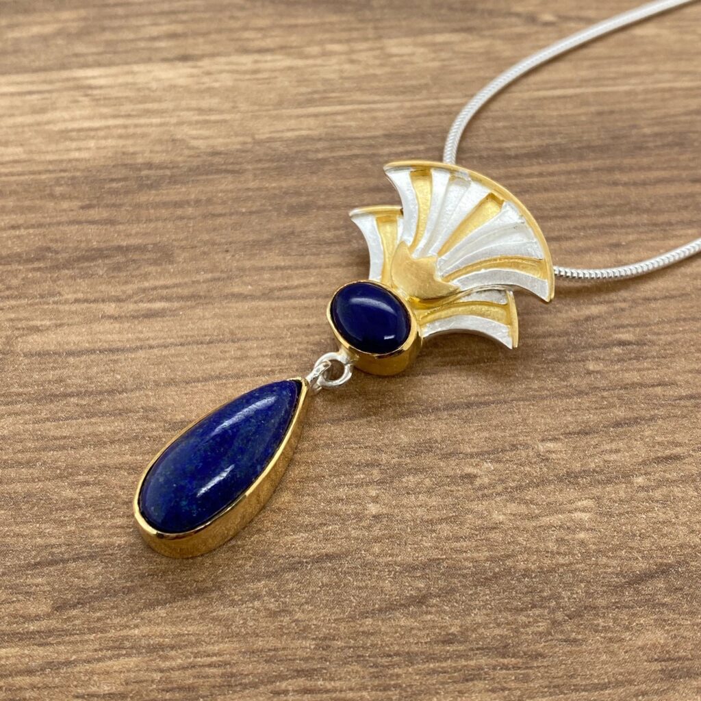 Gold and silver necklace with lapis lazuli stones.