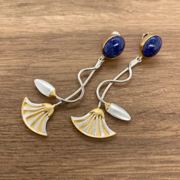 Gold and silver earrings with blue stones.