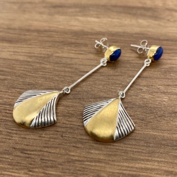 Gold and silver earrings with blue stones.