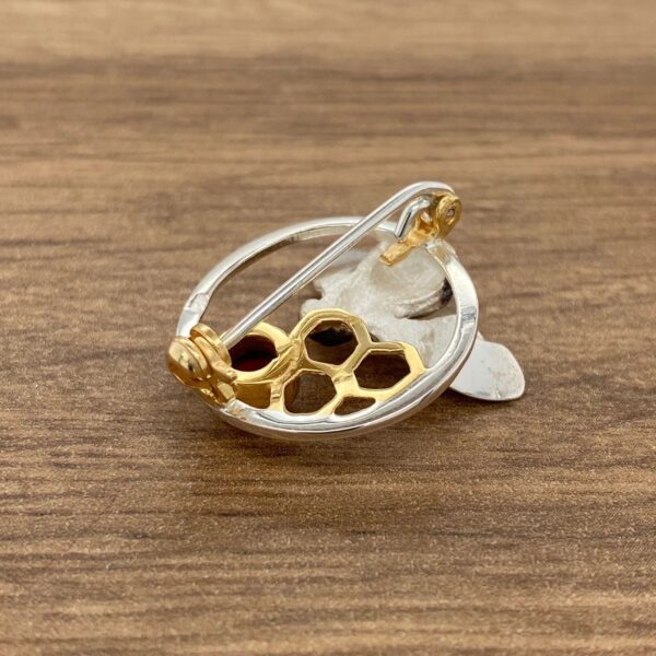 Silver and gold bee brooch with honeycomb.